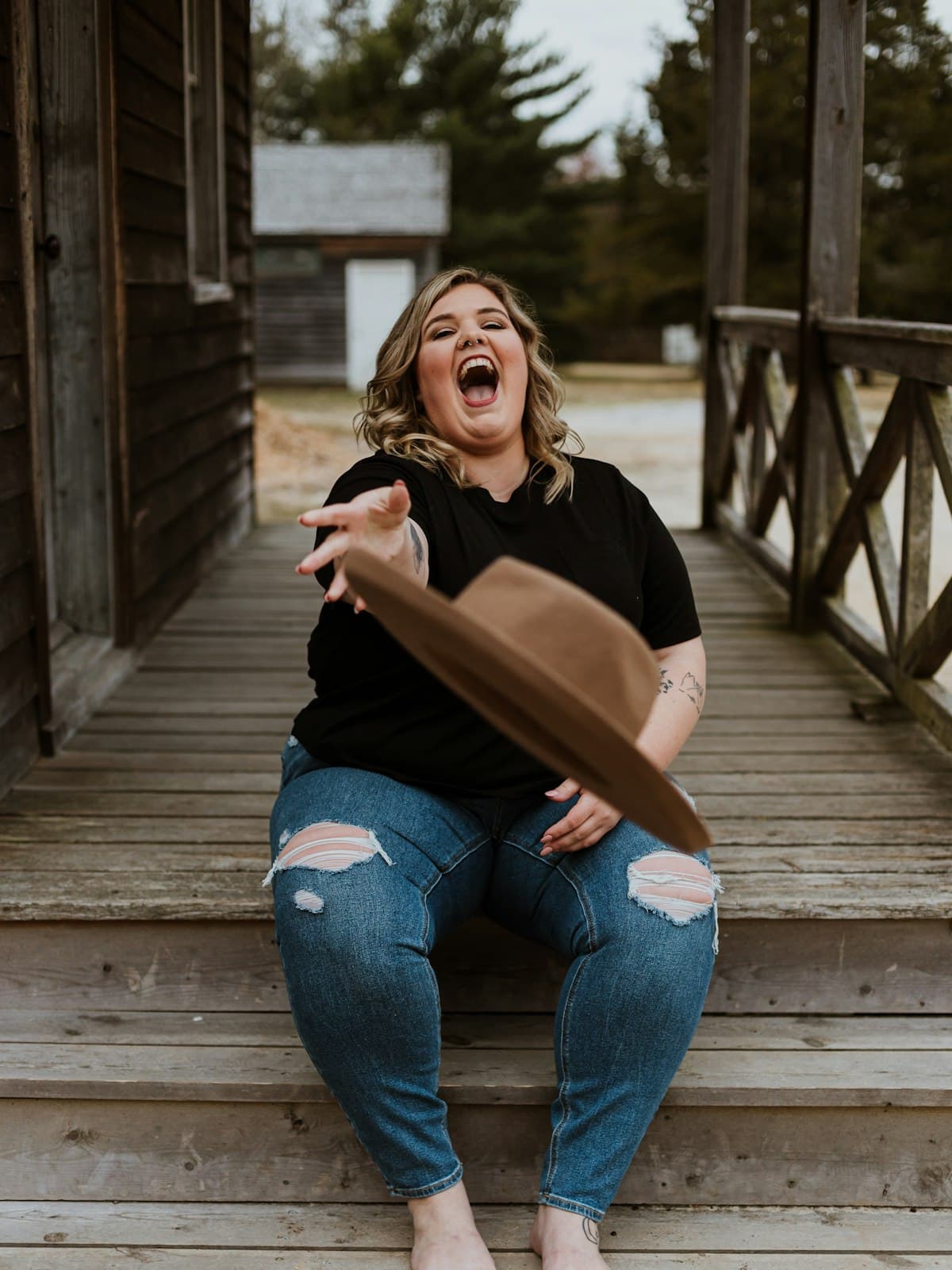 A woman laughing while sitting outdoors